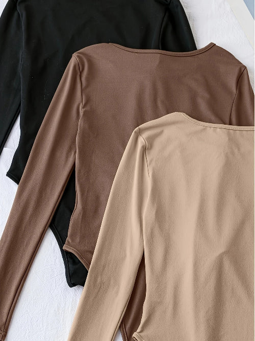 Zachte effen damesbodysuit met lange mouwen, crewneck en perfecte pasvorm voor optimaal comfort.