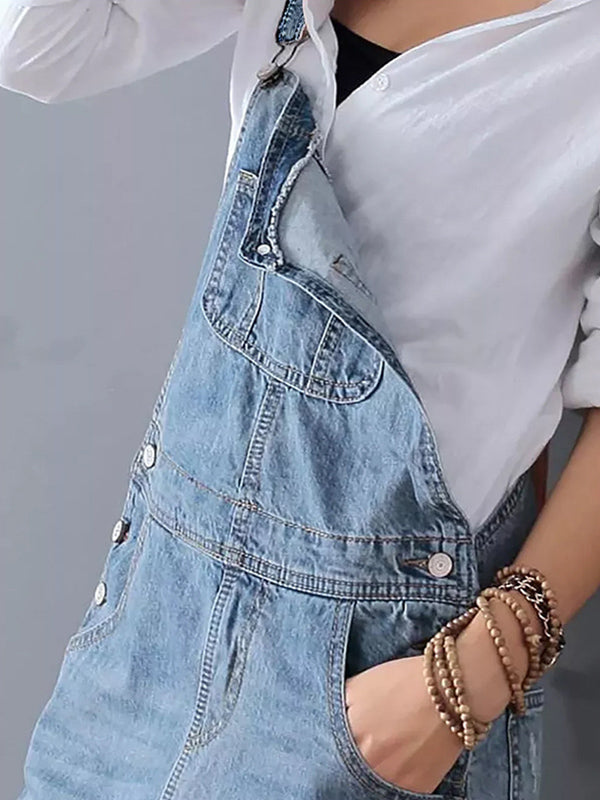Stijlvolle donkerblauwe dames dungaree jurk van denim met rugsplit, perfect voor een ontspannen zomerse dag.
