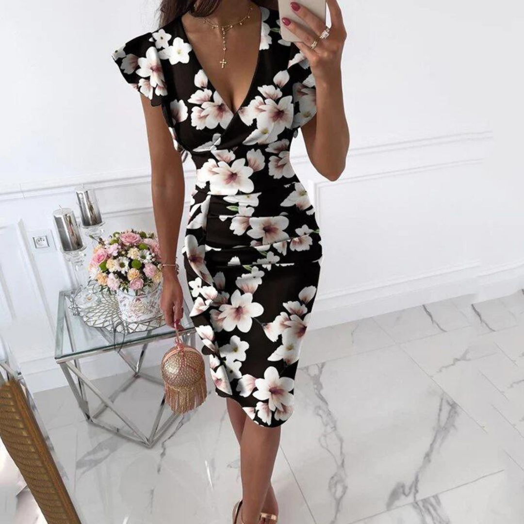 Dames zomerjurk met V-hals en aangerimpelde mouwen, perfect voor warme dagen.