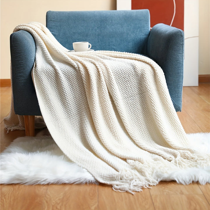 Gezellige gebreide deken met kwastjes en zachte bubbeltextuur voor ultiem comfort thuis.