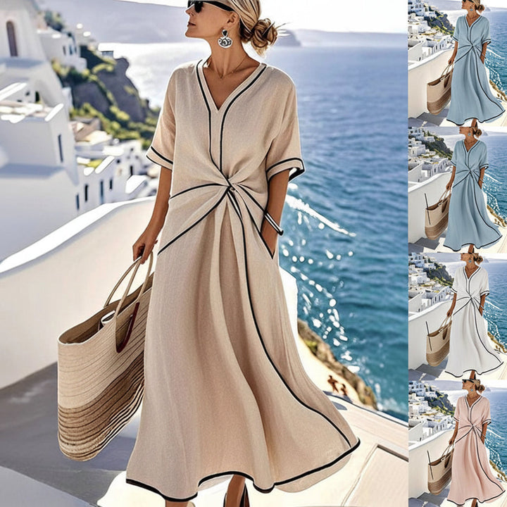 Elegante dames maxi-jurk met V-hals en contrasterende details. Ideaal voor zomerse dagen en feesten.