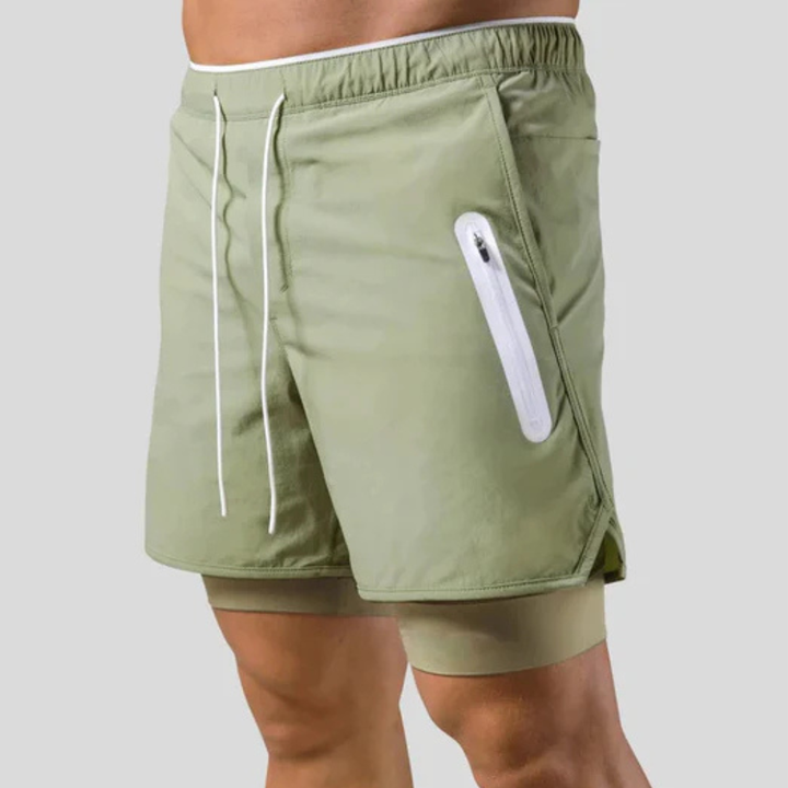 Vochtregulerende heren 2-in-1 sportbroek, combineert een losse short met compressielegging.