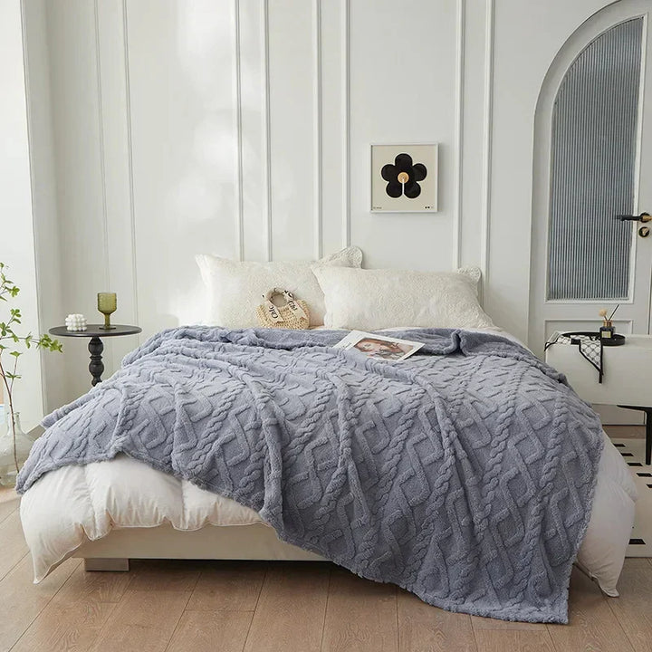 Tweezijdige deken van lamswol en flanel, heerlijk zacht en warm. Luxe plaid voor thuiscomfort.