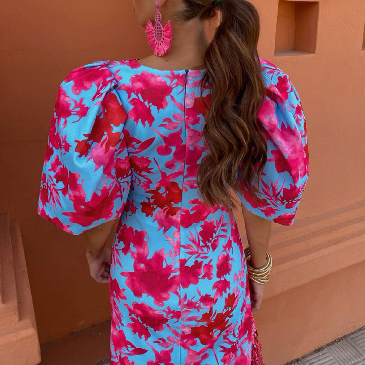 Vrouwenmode: elegante rosa midijurk met kleurrijke bloemenprint. Deze damesjurk is stijlvol en tijdloos.