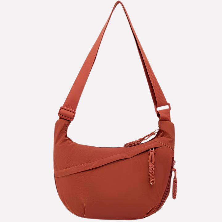 Elegante halvemaan tas van nylon. Dames crossbodytas met verstelbare band, geschikt als praktisch mode accessoire.