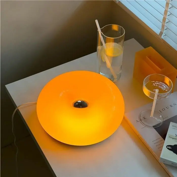 Moderne donut LED tafellamp van glas, ideaal voor sfeervolle verlichting in woonkamer of slaapkamer.