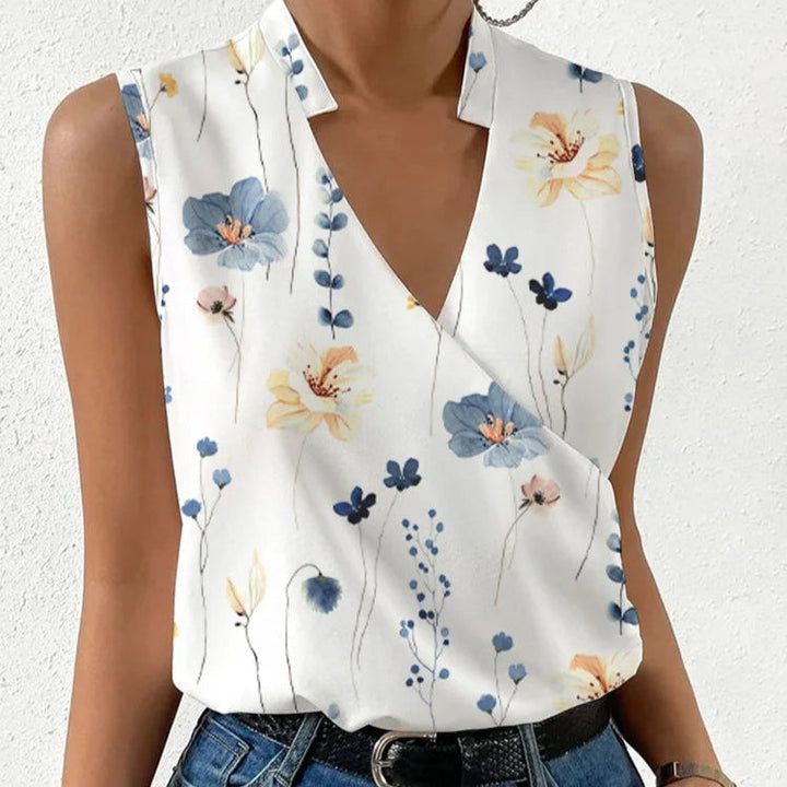 Damesblouse Lindsay met mouwloze pasvorm, diepe V-hals en trendy bloemenpatroon, comfortabel en modieus.