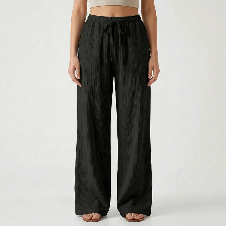 Lichte dames palazzo broek met wijde pijpen en elastische taille, perfect voor zomerse dagen.