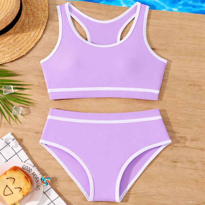 Meisjes bikiniset met gekruiste rug en vrolijke kleuren. Stijlvolle zwemkleding voor kinderen.