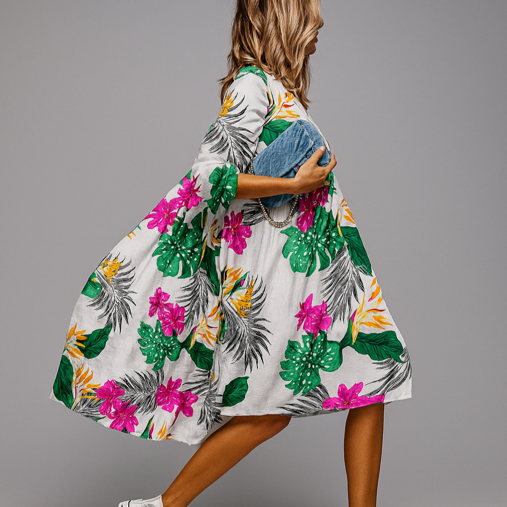 Elegante dames midi-jurk, oversized met vrolijke bloemenprint en trendy pofmouwen, perfect voor casual comfort.