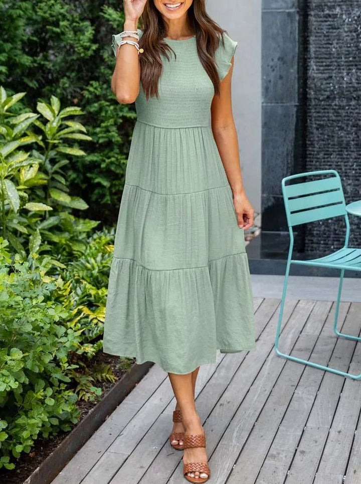 Elegante dames midijurk met luchtige vlindermouwen, ideaal voor een comfortabele zomerlook.