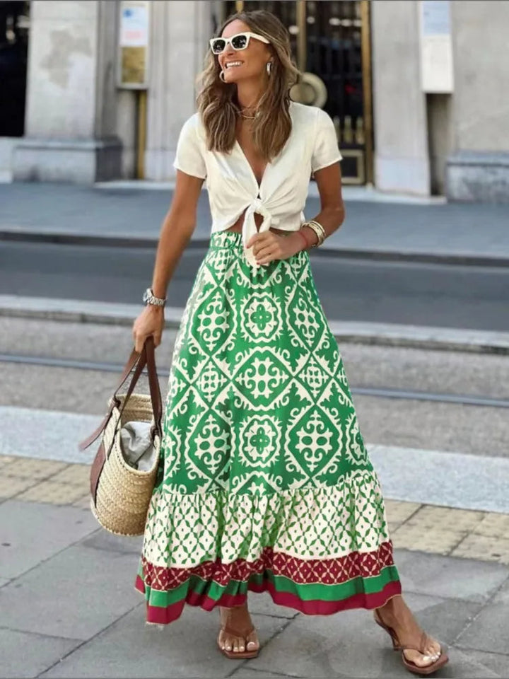 Dames Liora midi rok met vrolijke retro print, perfect voor een stijlvolle zomeroutfit of casual dagjes uit.