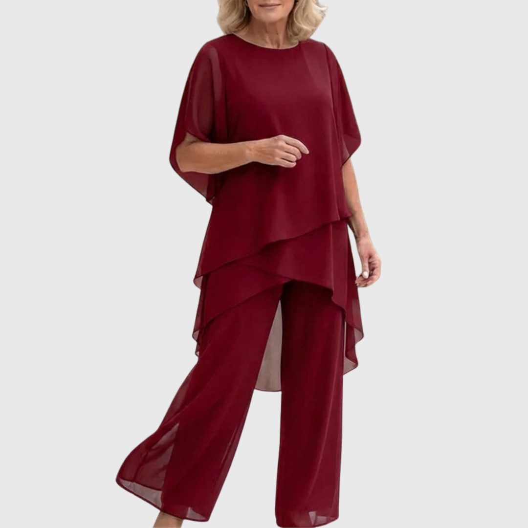 Elegante tweedelige dames set met asymmetrische top en vloeiende palazzo broek. Perfect voor zomerse evenementen.