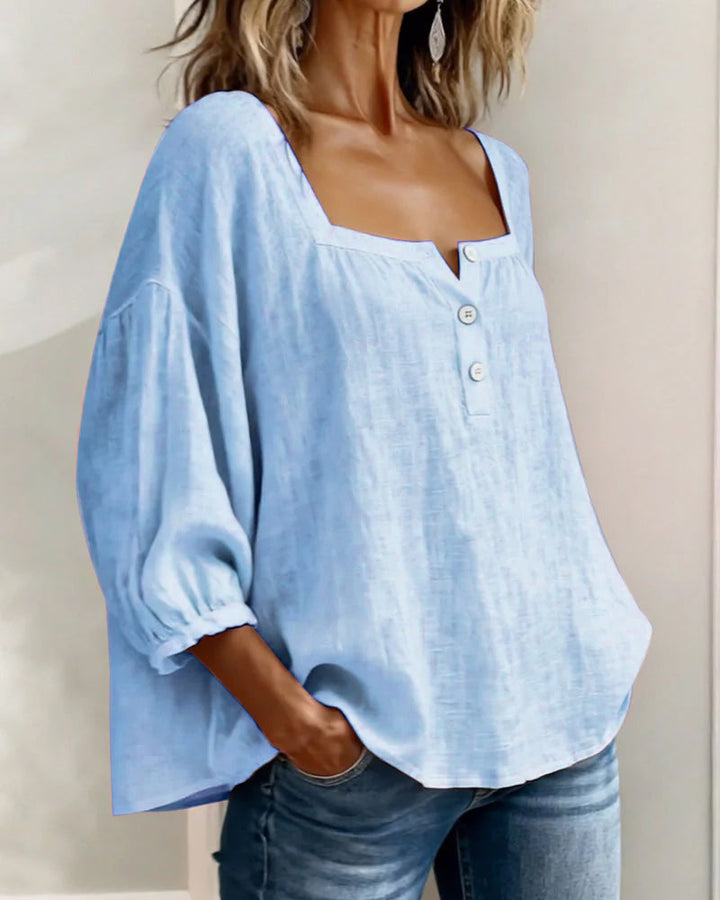 Platliggende damesblouse met elegante pofmouwen en vierkante hals, perfect voor lente en zomer.