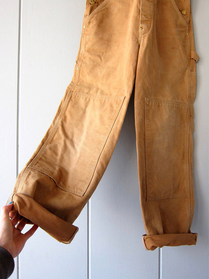 Moderne unisex canvas dungarees met praktische details. Stevige stof, ideaal voor actieve werkzaamheden.