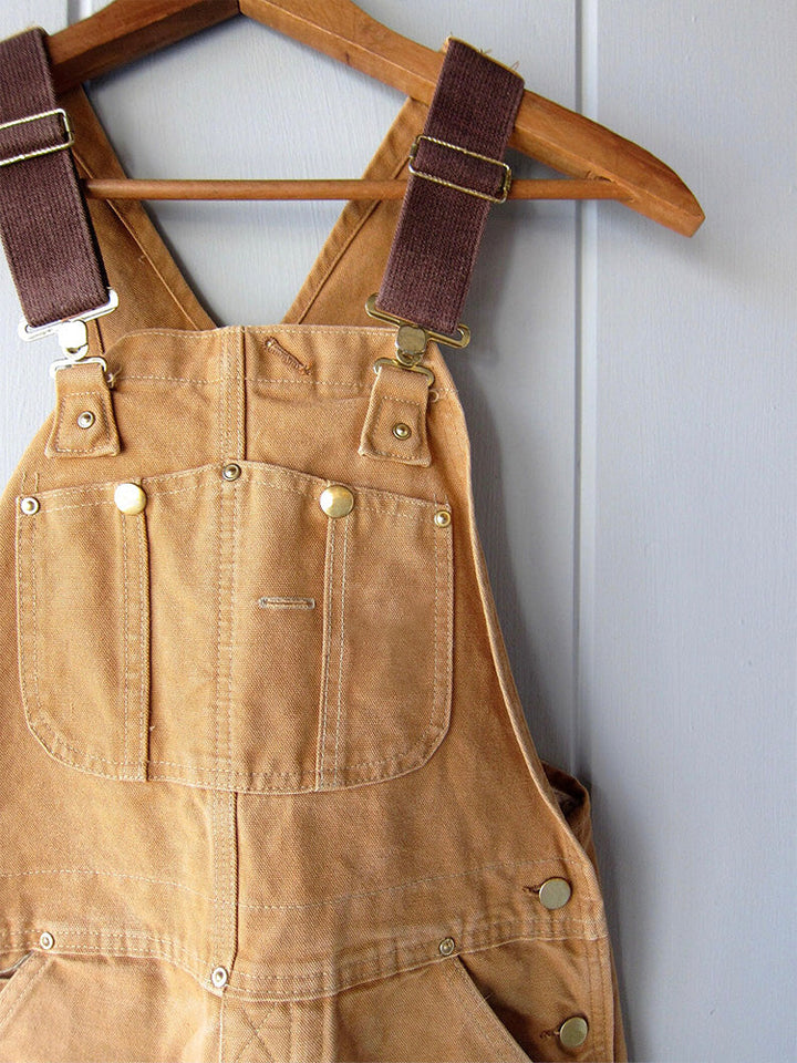Unisex werkoveralls van canvas met multifunctionele zakken. Stevig en ideaal voor het opbergen van gereedschap.