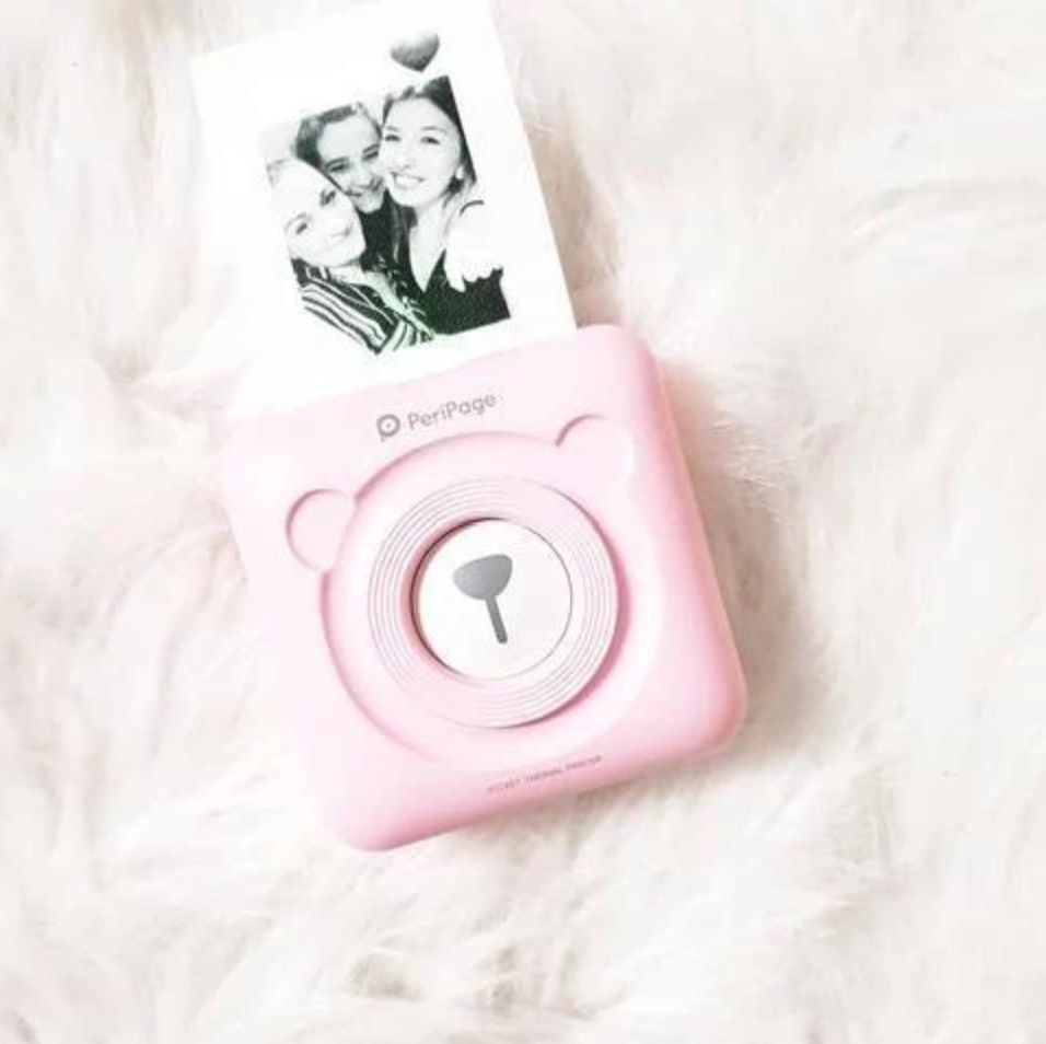 Witte draagbare mini fotoprinter; inktvrij, mobiel printen via Bluetooth. Essentieel gadget voor fotografie.