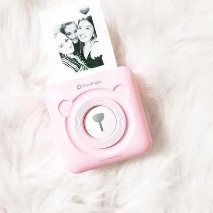 Witte draagbare mini fotoprinter; inktvrij, mobiel printen via Bluetooth. Essentieel gadget voor fotografie.