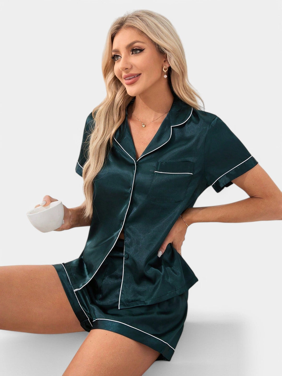 Glanzende satijnen dames pyjama met levendige tropische print en strakke biesafwerking.
