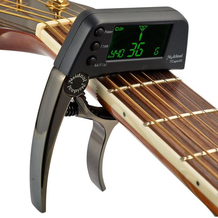 Compacte TuneGrip 2-in-1 capo en stemapparaat voor gitaar, bas, ukelele, viool. Stevig aluminium ontwerp.