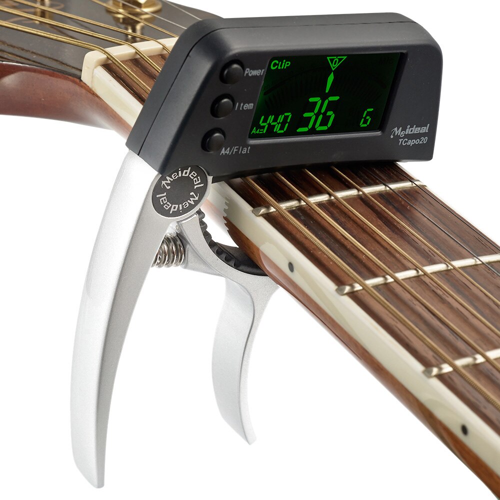 Universele TuneGrip 2-in-1 gitaar capo en tuner. Perfect voor diverse instrumenten: gitaar, bas, ukelele.
