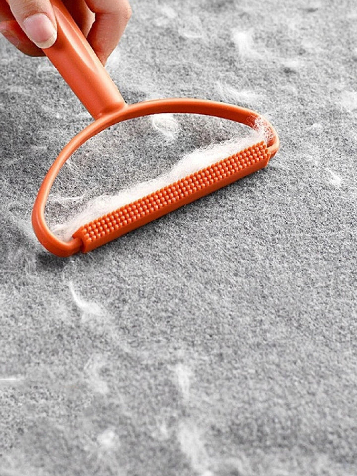 Universele stof- & pluisverwijderaar voor textiel en dierenhaar. Essentiële huishoudelijke schoonmaaktool.