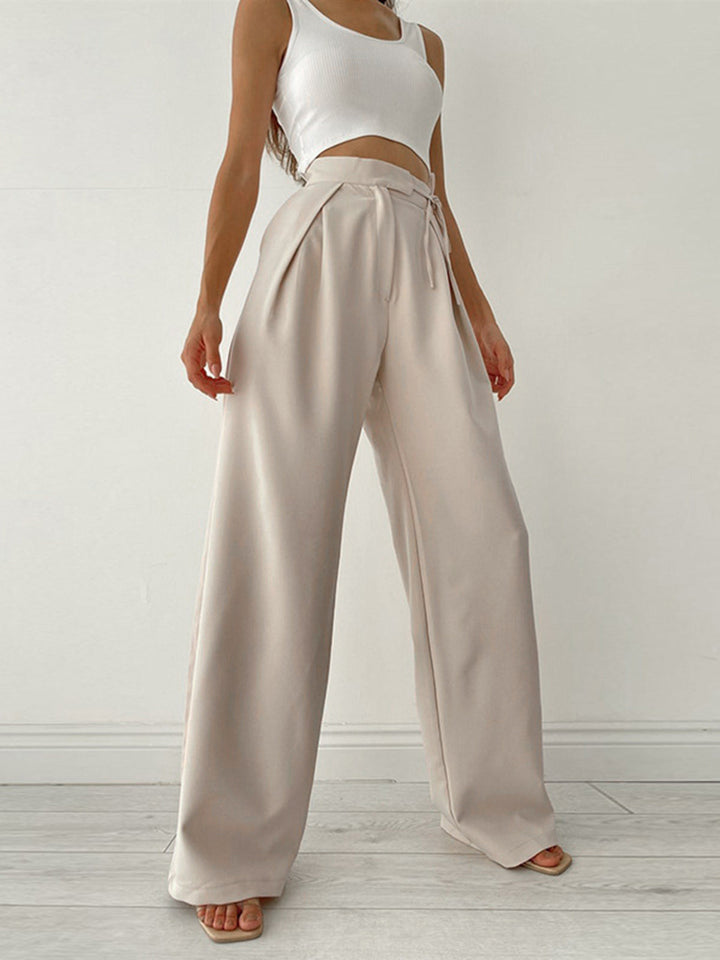 Comfortabele beige high waist pantalon met wijde pijpen en taille strik, voor een moeiteloos elegante stijl.