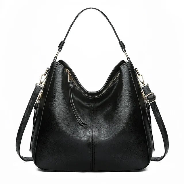 Chique leren dames handtas met gouden ritssluiting en accenten, een elegant accessoire.