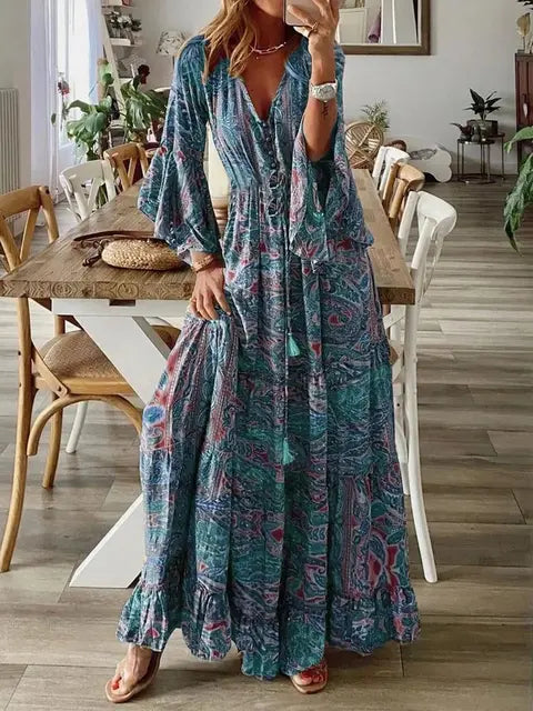 Dames bohemian maxi jurk met levendige bloemenprint, wijde mouwen en elegante hoge taille. Perfect voor zomer.