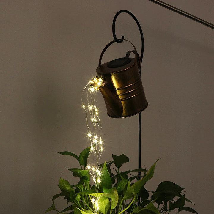 Detailopname van de magische waterdruppel LED verlichting die uit de decoratieve gieter stroomt.