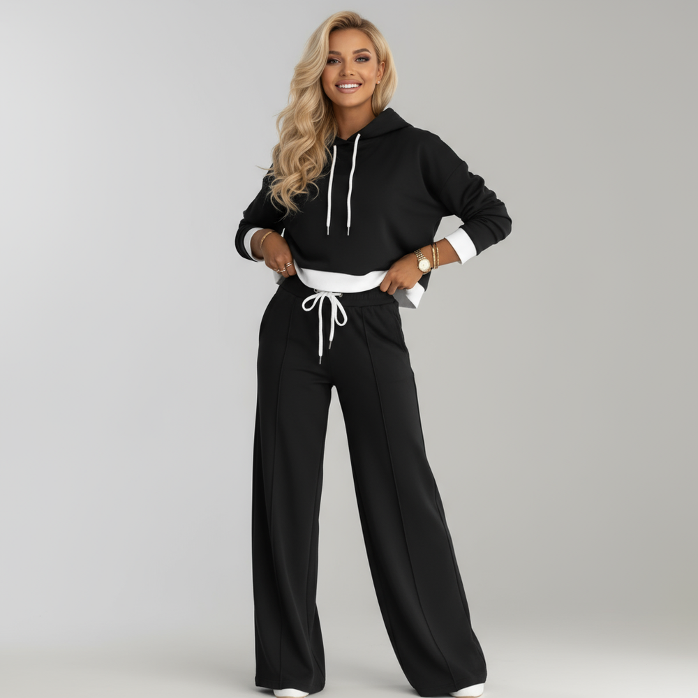 Stijlvolle dames casual set: modieuze hoodie en relaxte wijde broek, perfect voor thuis of onderweg.