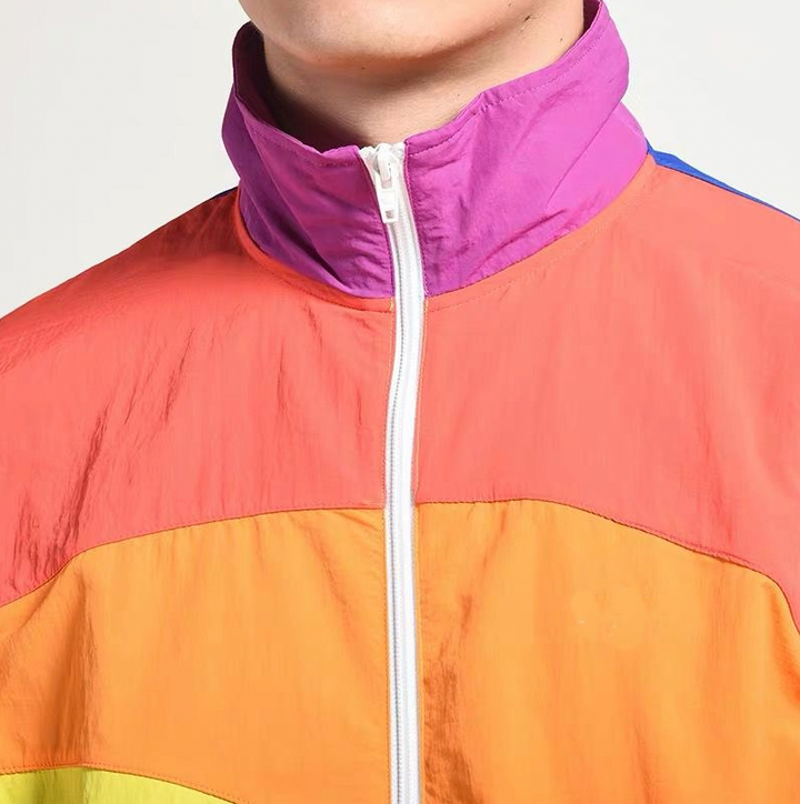 Levendig regenboog jack met jaren '90 retro design. Unisex en stijlvol, ideaal voor buitenkleding in de lente.