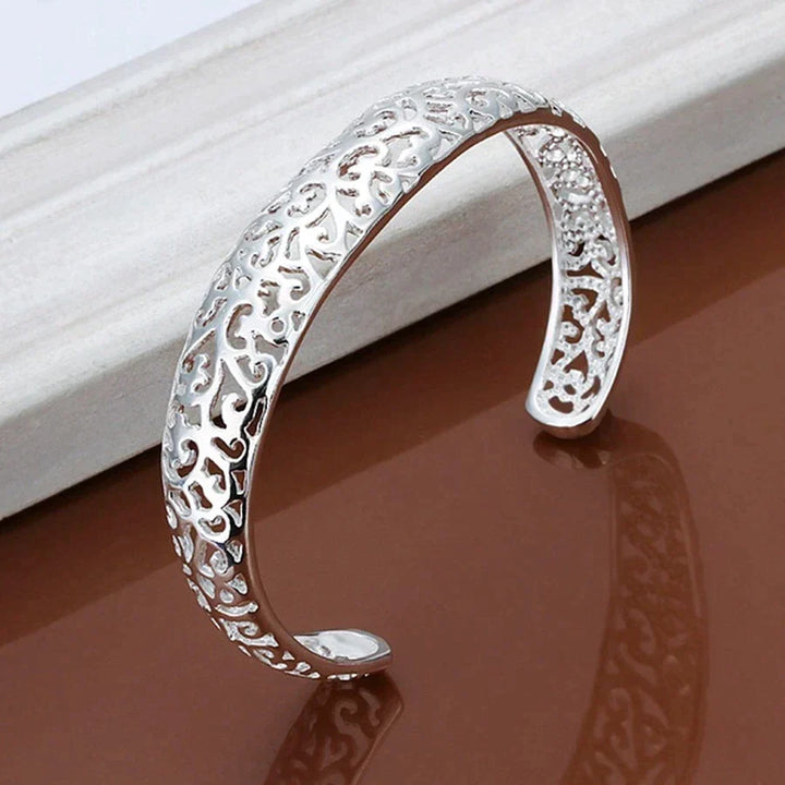 Model draagt een stijlvolle verzilverde filigraan armband voor dames, perfect voor elke outfit.