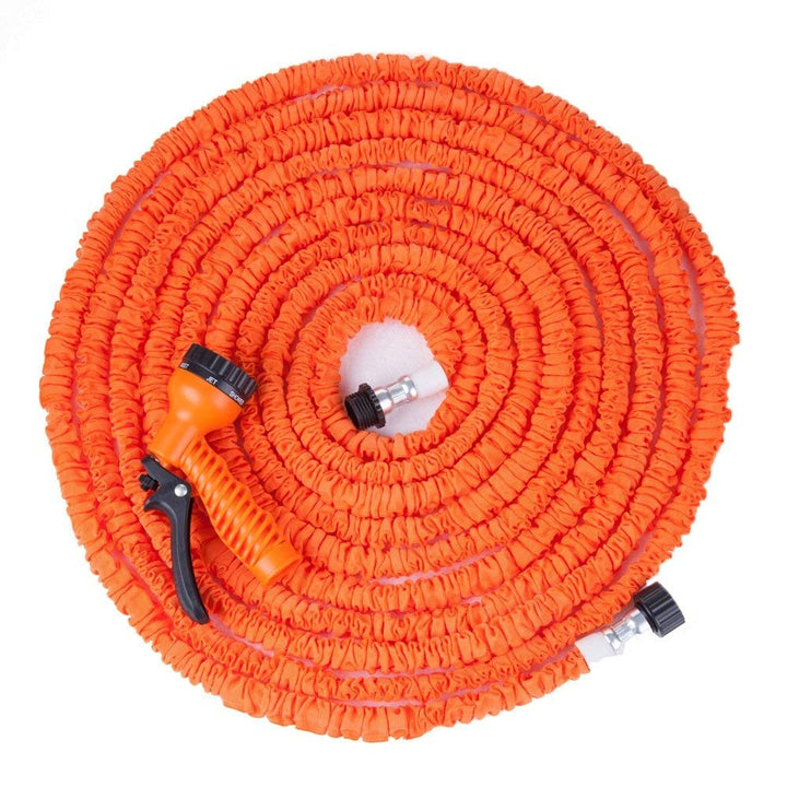 De uitzetbare tuinslang met sproeikop reinigt een terras. Krachtig en flexibel voor schoonmaakklussen.