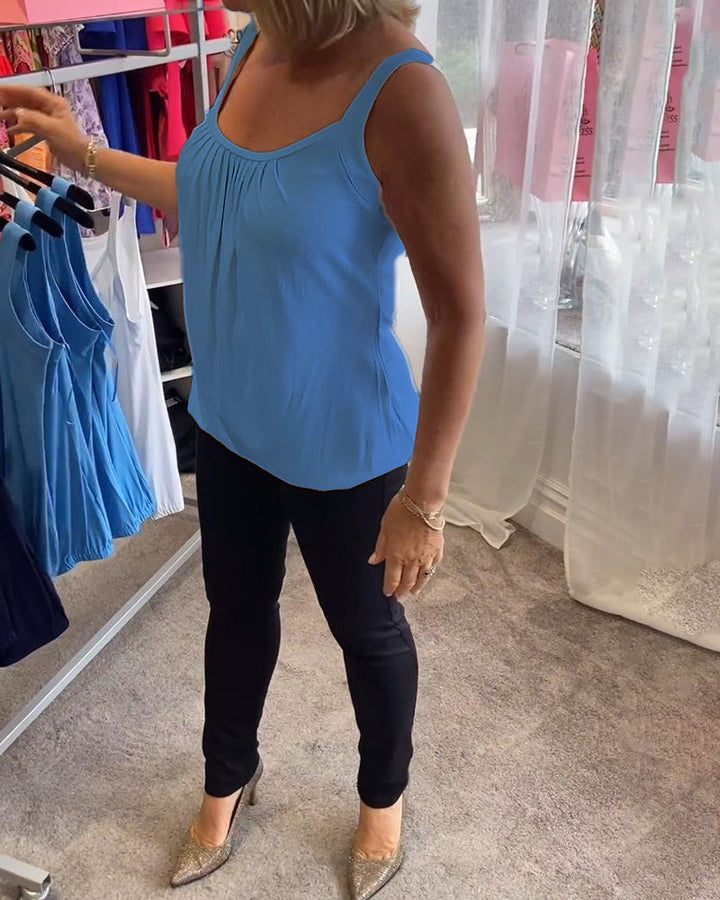 Stijlvolle dames top: mouwloos, geplooide U-hals, relaxte pasvorm. Perfecte basis top.