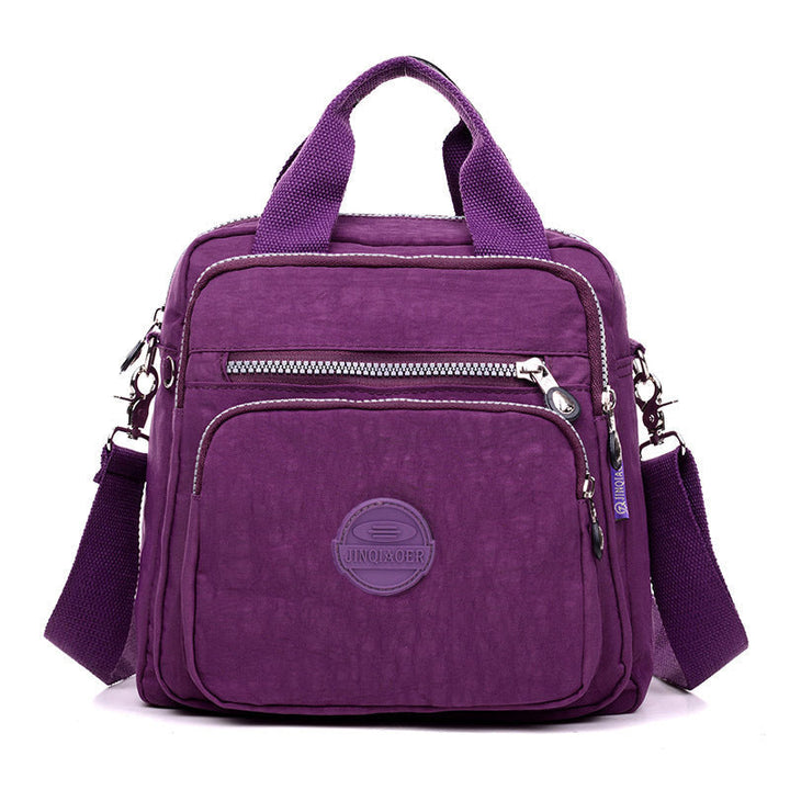Zwarte multifunctionele damestas, waterdicht en lichtgewicht, te gebruiken als crossbody, schoudertas of rugzak.