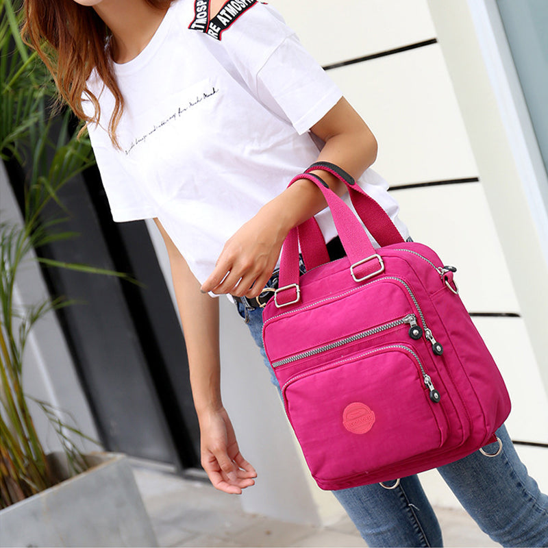 Stijlvolle waterdichte schoudertas voor dames, veelzijdig als rugzak of crossbody, met organizer.