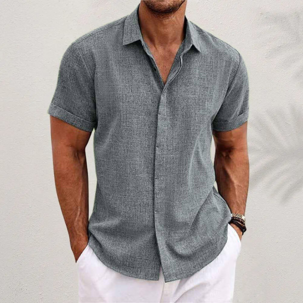 Model draagt een casual, stijlvol heren zomer overhemd. Comfortabele mode voor relaxte zomerdagen.