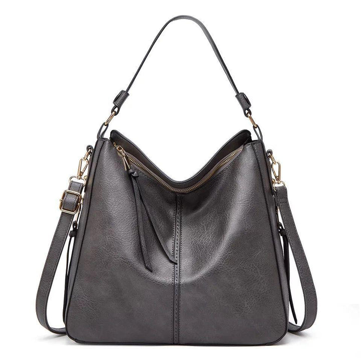 Stijlvolle leren dames handtas uit de nieuwe collectie, met glimmende gouden hardware, elegant.