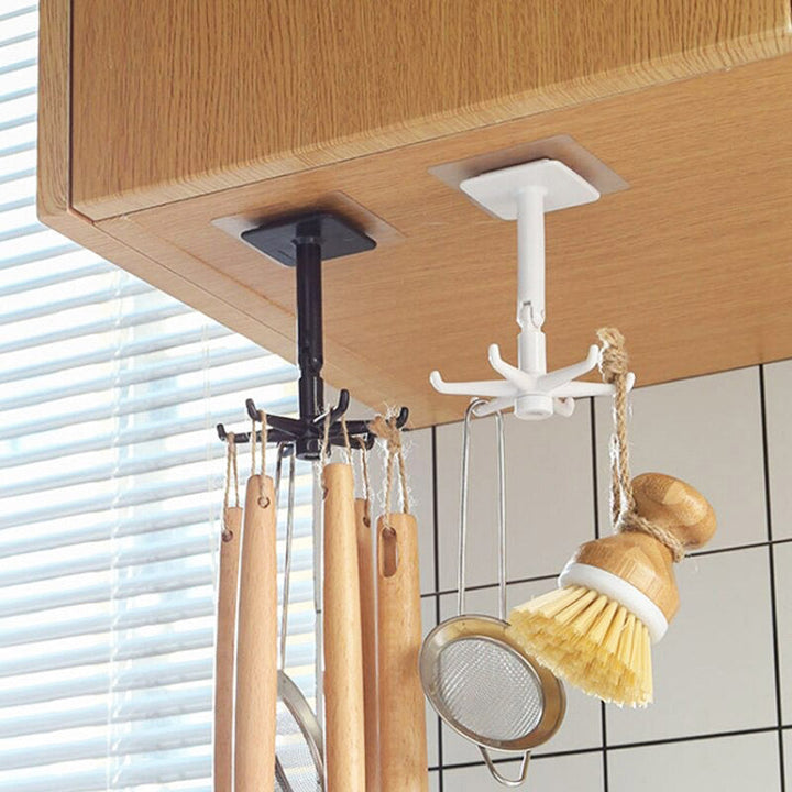 Wit roterend wandrek met 6 haken, modern en praktisch voor het ophangen van keukengerei en andere accessoires.