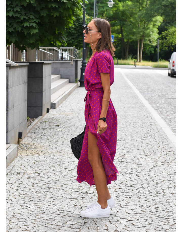 Vrouw draagt elegante dames zomer maxi jurk met bloemenprint, ideaal voor een relaxte vakantiedag of casual uitje.