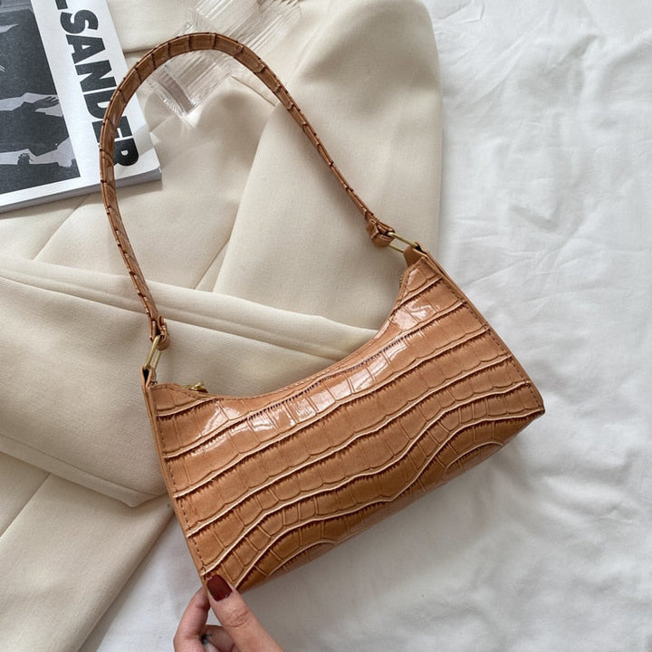 Chique en compacte dames handtas, ideaal voor essentiële items.