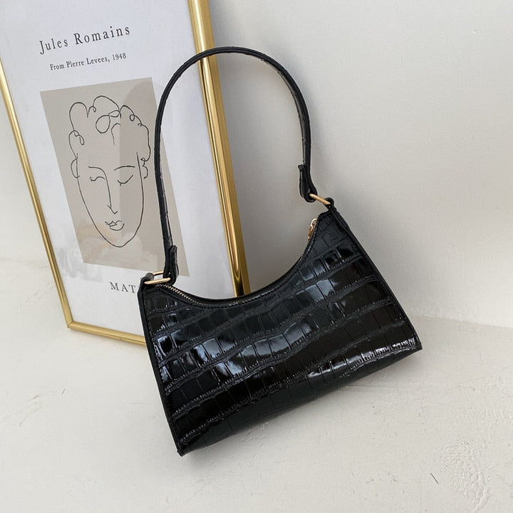 Elegant dames accessoire, deze chique schoudertas maakt je look compleet.