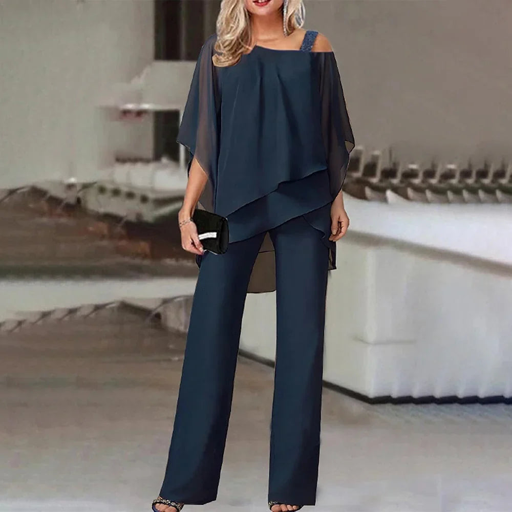 Elegante zwarte dames cold-shoulder jumpsuit. Modieus, comfortabel en trendy. Perfecte feestelijke kleding.