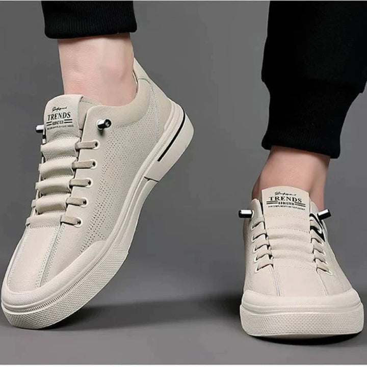 Paar stijlvolle herensneakers, beige en wit, klaar om elke casual herenoutfit te stylen met comfort.