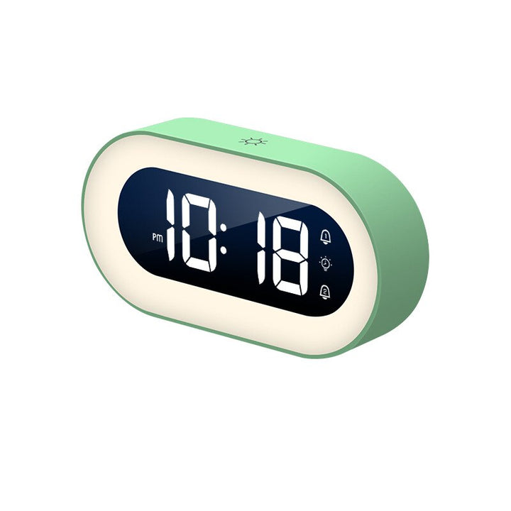 Compacte draadloze reiswekker Lumino met digitaal display en geïntegreerd nachtlampje, perfect voor onderweg.