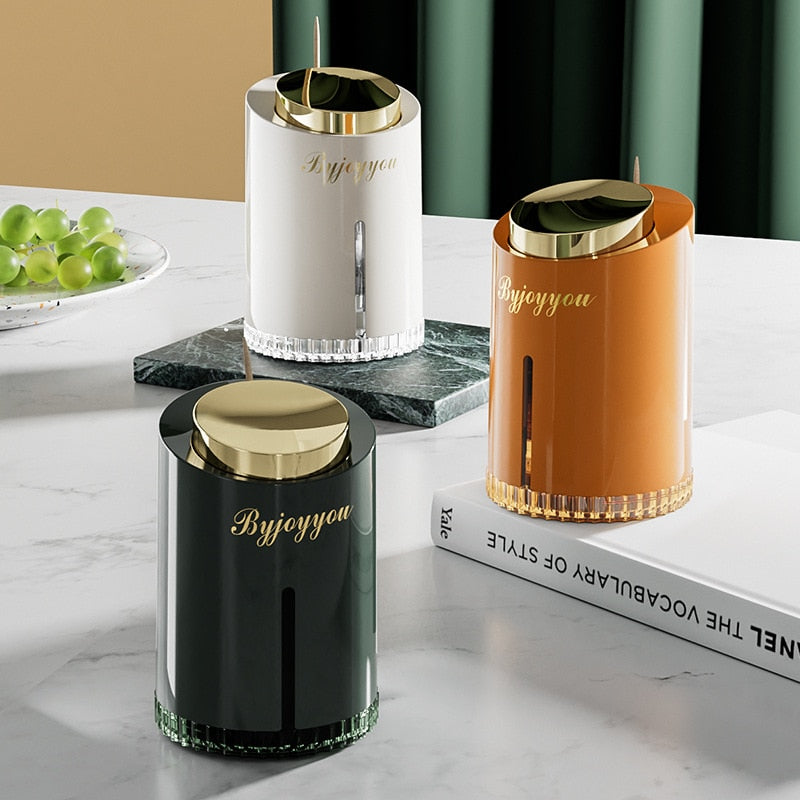 Elegante pop-up tandenstoker houder met modern design voor hygiënische opslag op tafel of keuken.