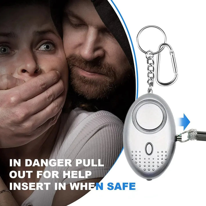 Zwart compact veiligheidsalarm met ingebouwde LED-zaklamp voor extra zichtbaarheid en hulp in het donker.