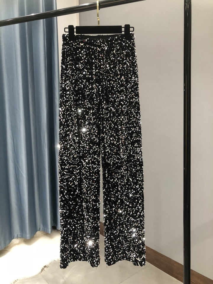 Comfortabele dames glitterbroek met vloeiende wijde pijpen, perfecte feestkleding voor een hele avond dansplezier.
