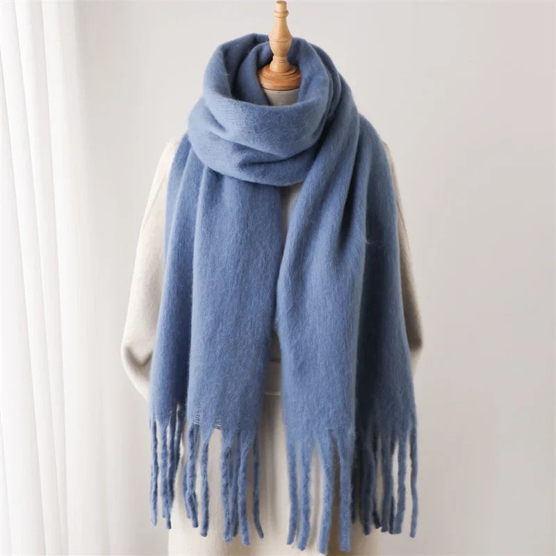 Deze zachte unisex wintersjaal met kasjmier look en grote kwasten combineert warmte en elegantie.